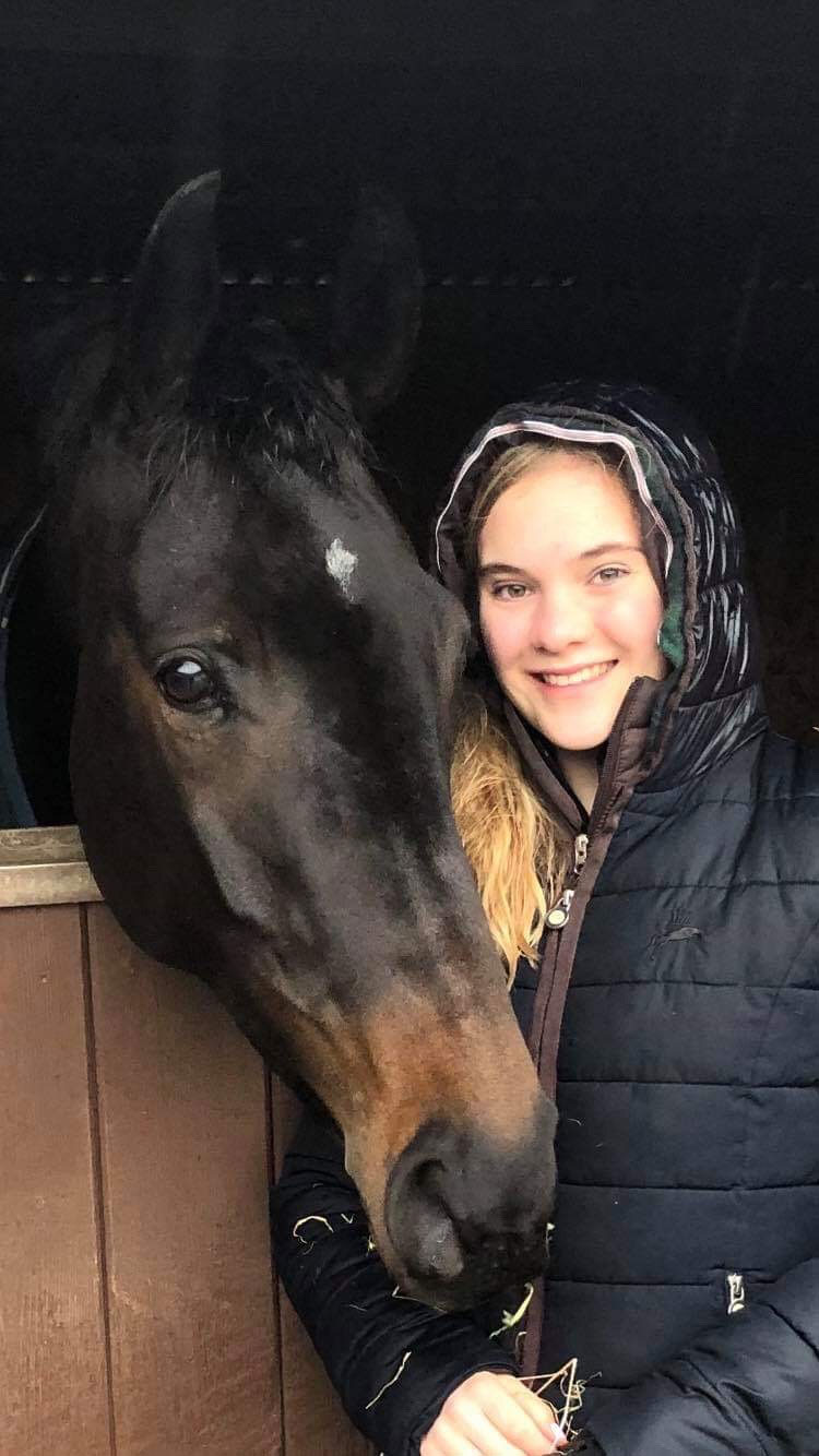 Olivia Whitelaw and horse in stable